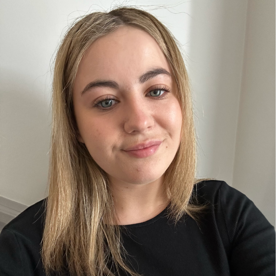 Alice, girl with blond hair smiling at the camera