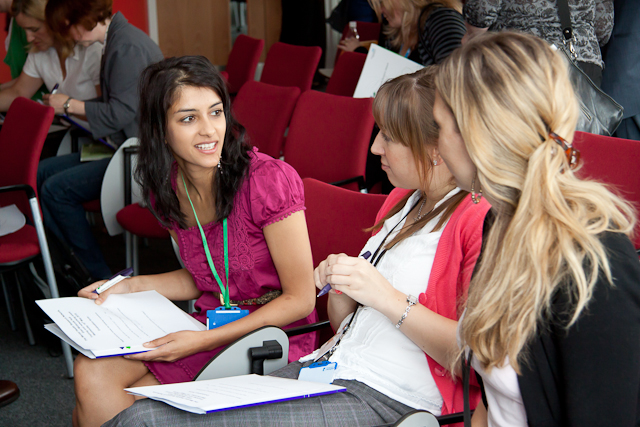 People sat down having a conversation at a conference