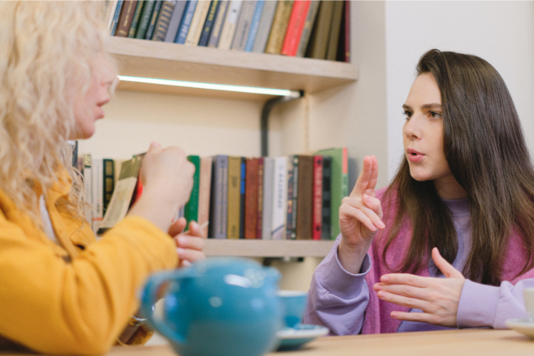 Two women doing sign language